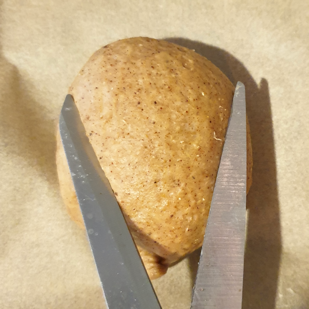 The first cut through the top of a little vegan brioche loaf to make the ears of an easter Bunny bun