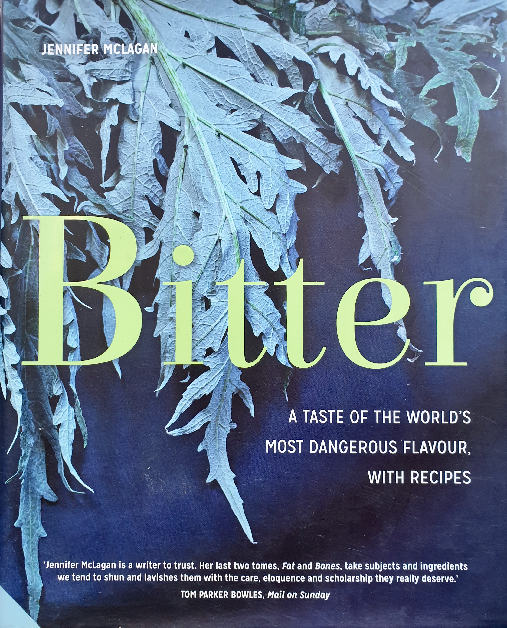 Cover of the cookbook titled 'Bitter' by Jennifer McLagan, showcasing a dense layer of artfully arranged dark green, feathery leaves of some bitter greens. The book's subtitle, 'A Taste of the World's Most Dangerous Flavour, with Recipes,' is displayed in yellow lettering, emphasizing the theme of exploring the culinary uses of bitter flavors in various dishes.