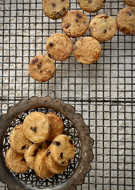 a dish of melt in the mouth olive shortbread on a baking rack next to more olive shortbread